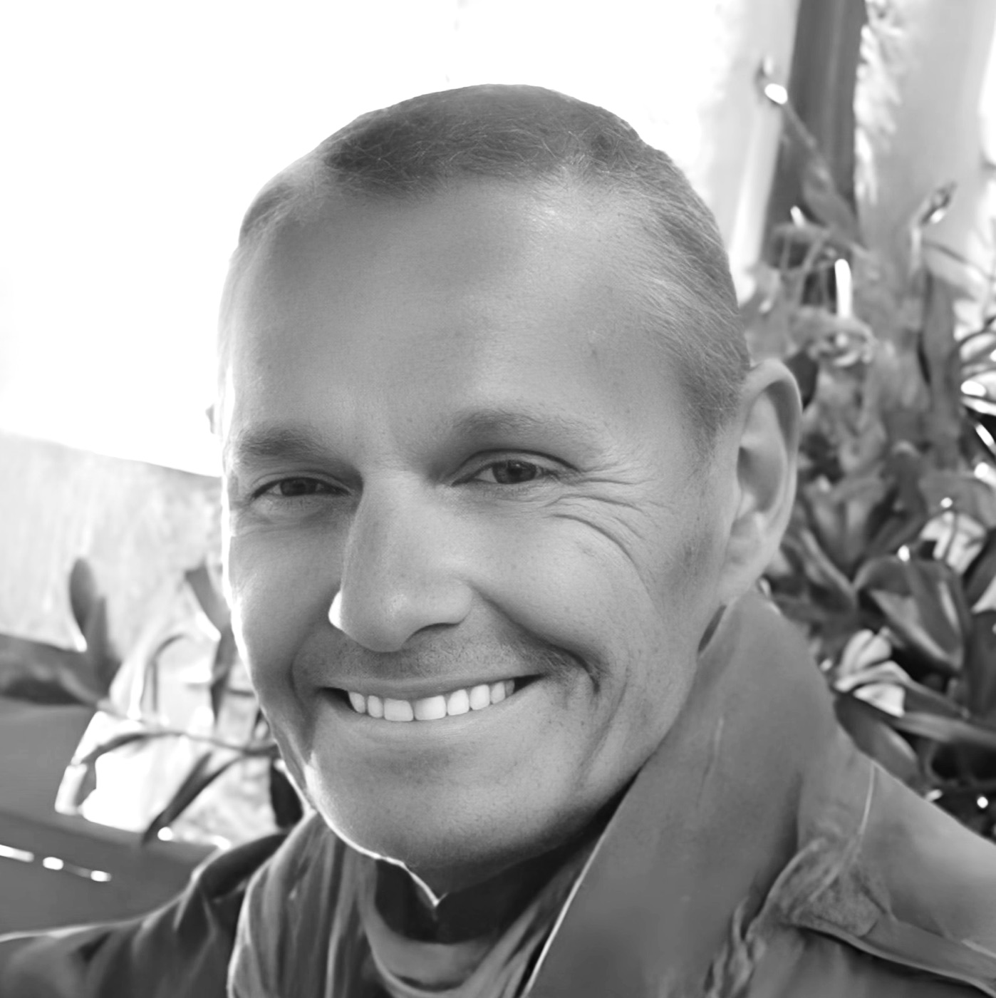 Black and white portrait of Thomas H. Kay, smiling